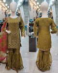 Ladies green kameez and Gharara with intricate hand embellishments