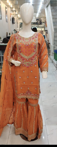 Ladies Orange kameez and Gharara with intricate hand embellishments